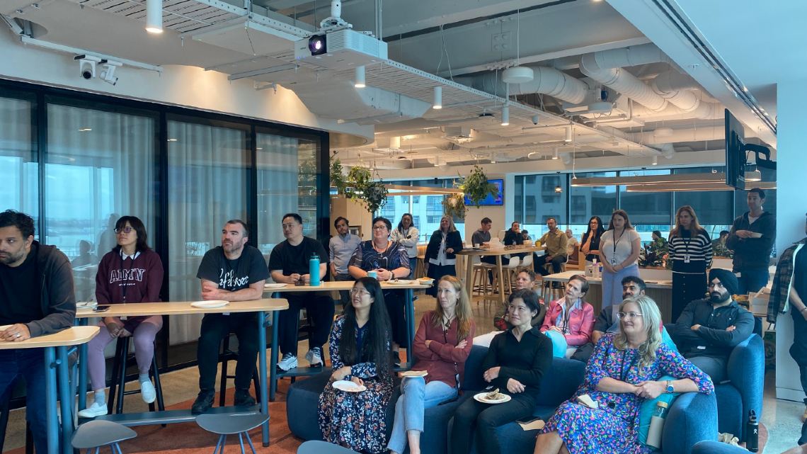 Employees gathered in an office for a workplace presentation or training session.