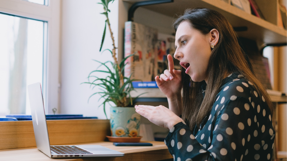 A woman on a video call speaking to someone in NZSL.