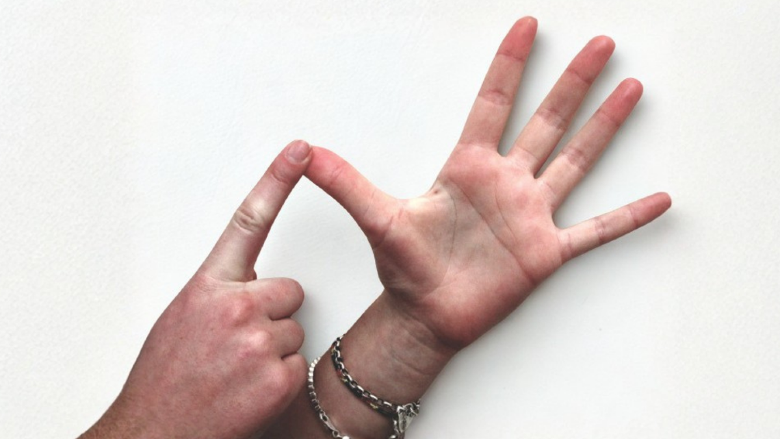 Hands signing with the letter A