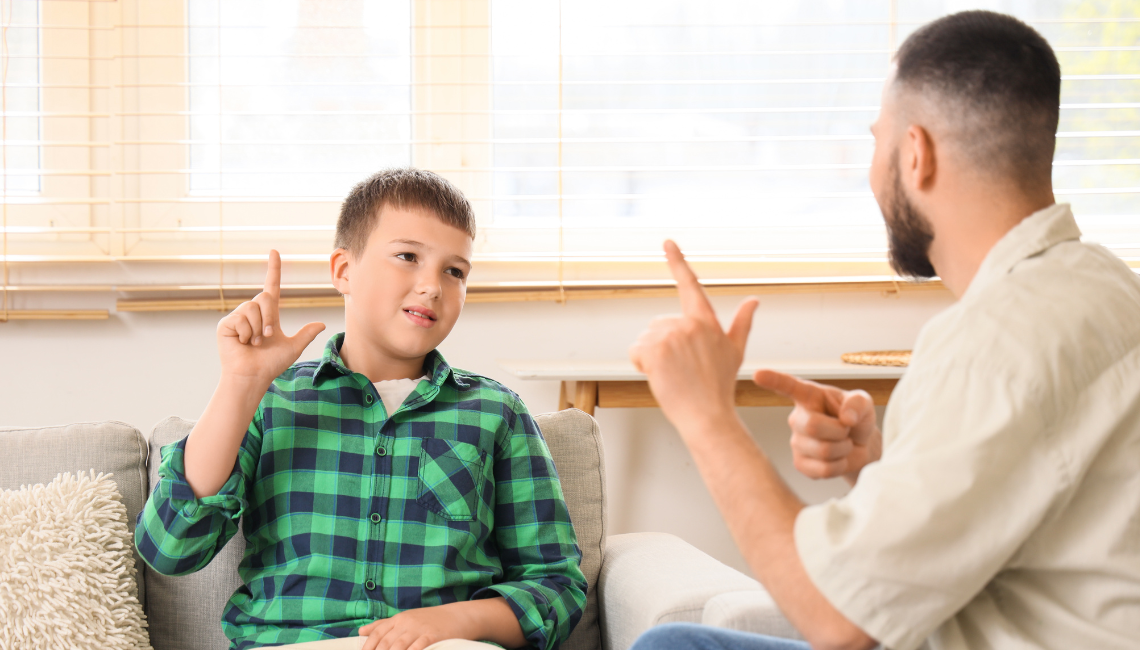 Middle aged man and a kid using sign language