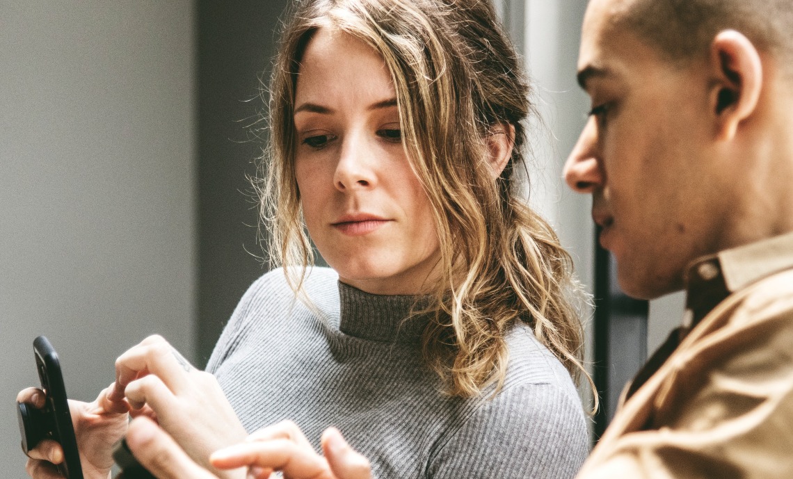 Two people reviewing content