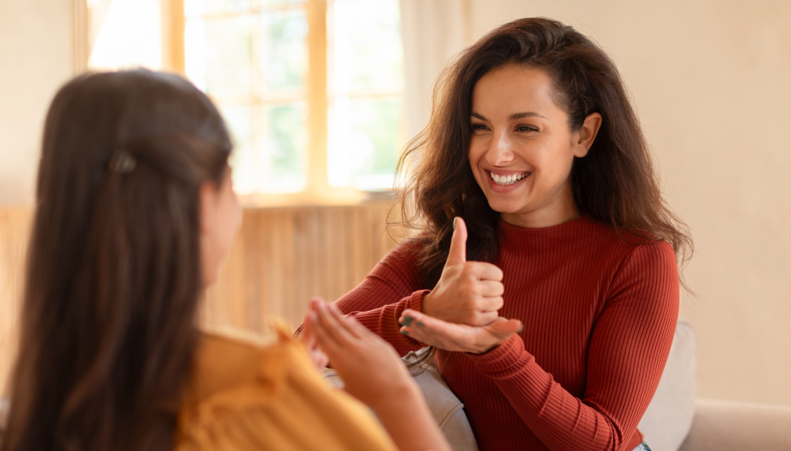 Two young women using sign language