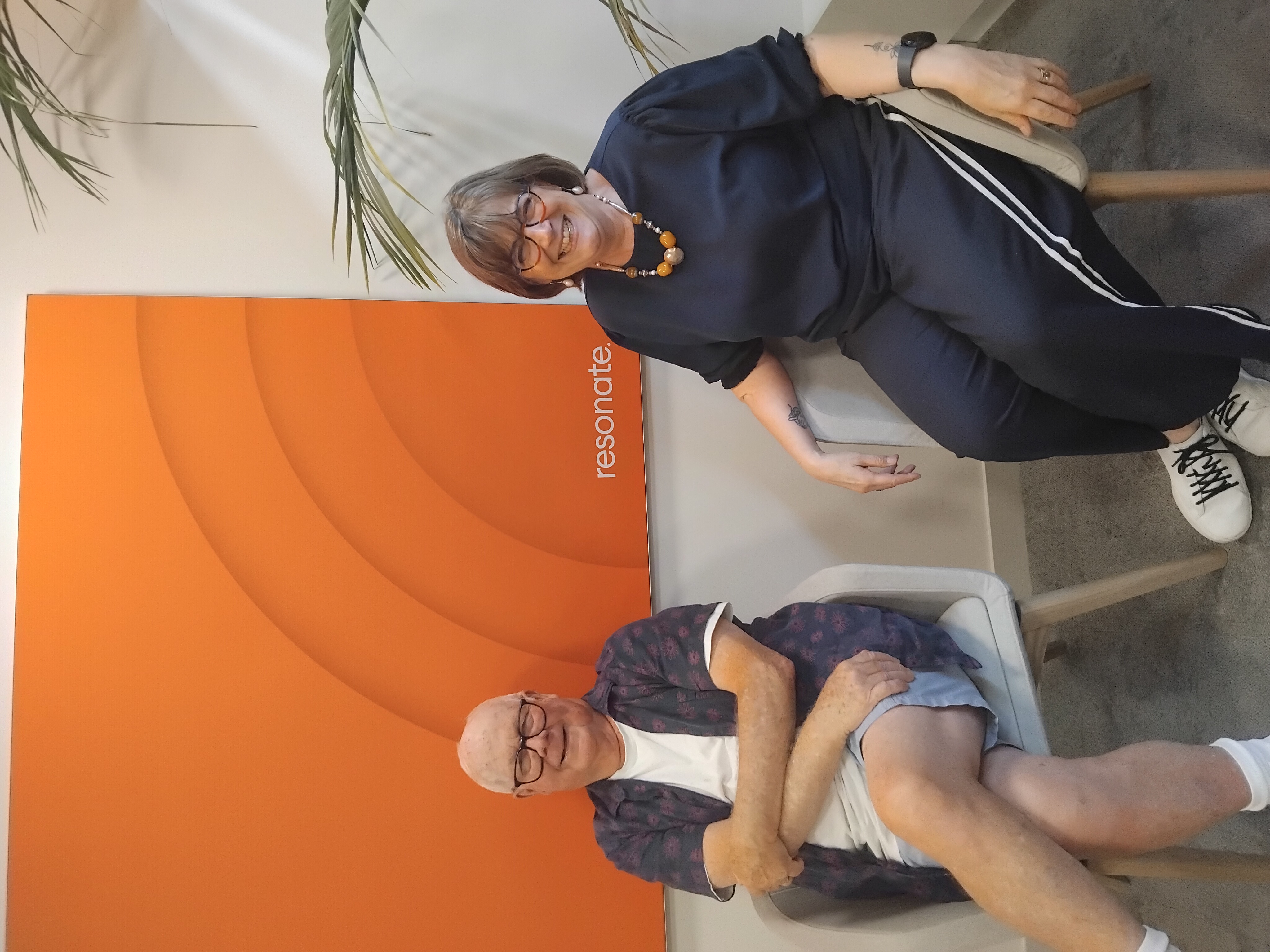 Barry and Karen sitting on a chair next to one another.