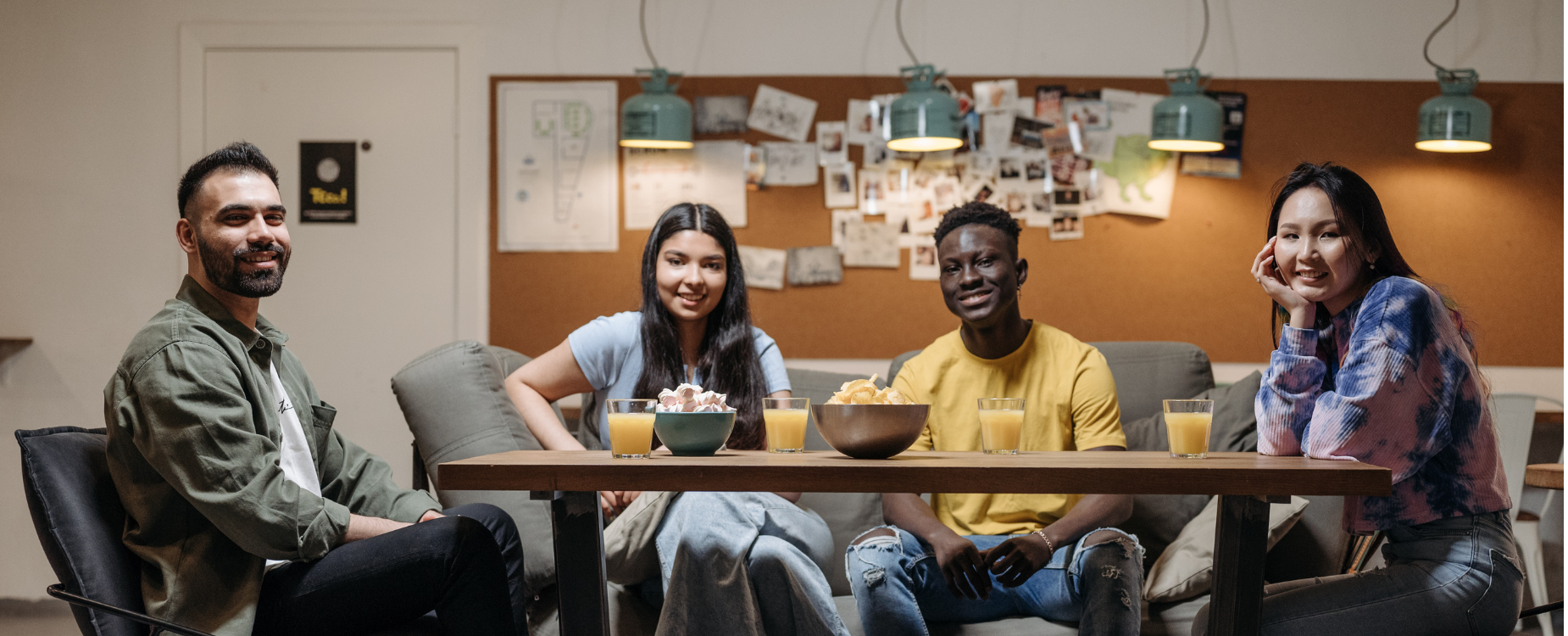 Young adult sitting around a table in a communal area