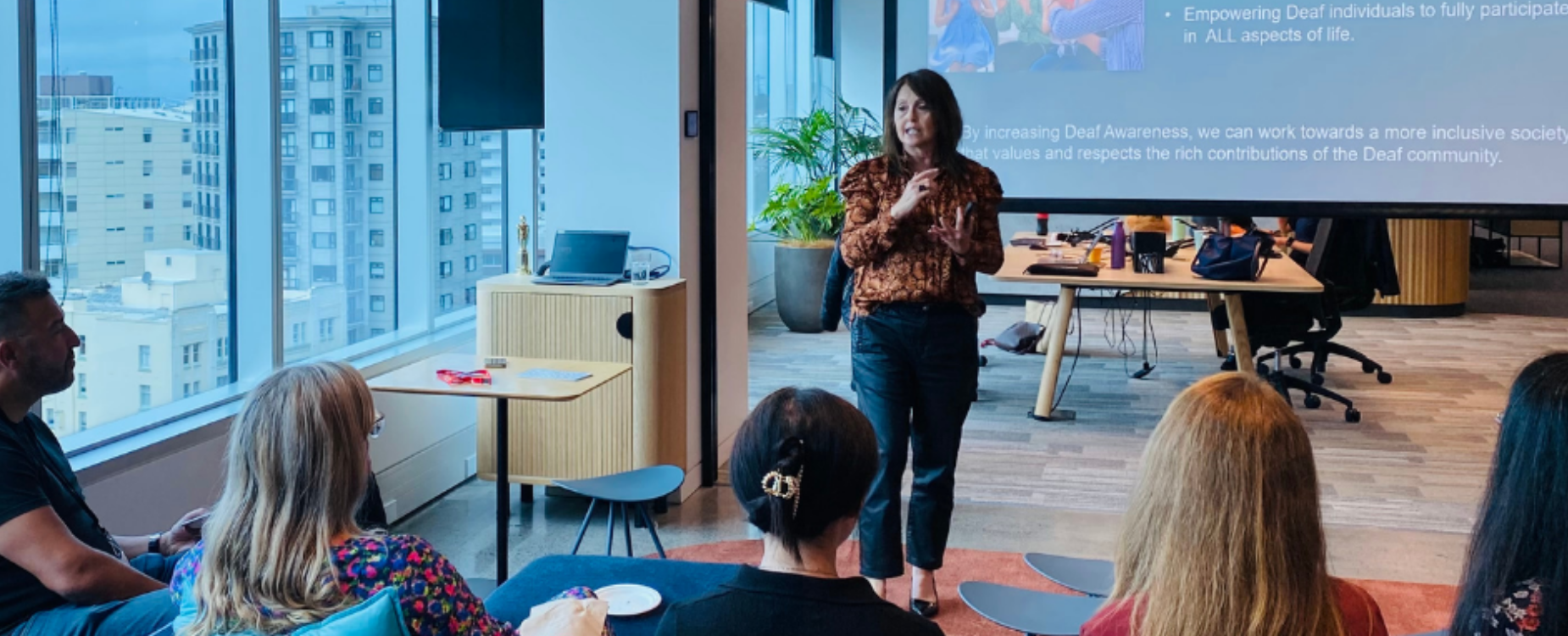 Presenter speaking to employees during a Hearing Accredited Workplace session.